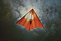 Hang glider backlit by sun